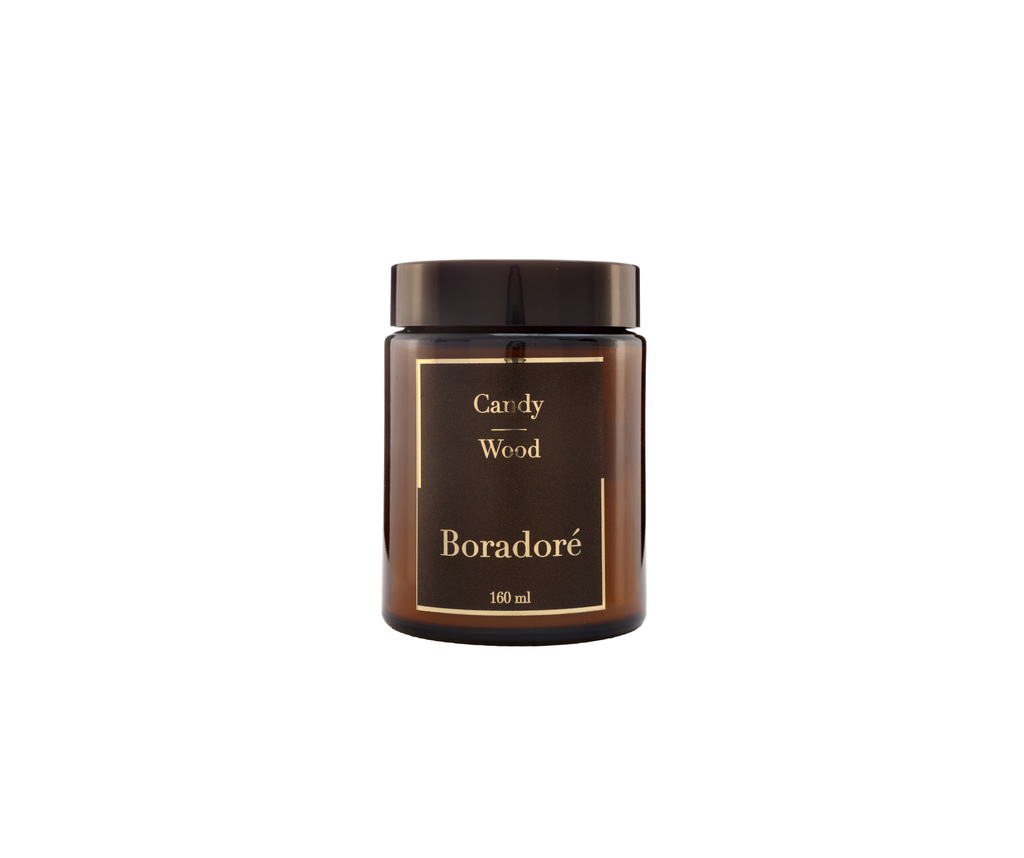 Boradoré Candy Wood scented candle in amber glass jar on white background

