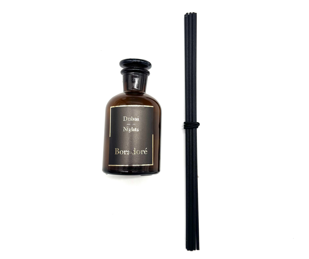 Boradoré Dubai Nights reed diffuser in amber glass bottle on white background
