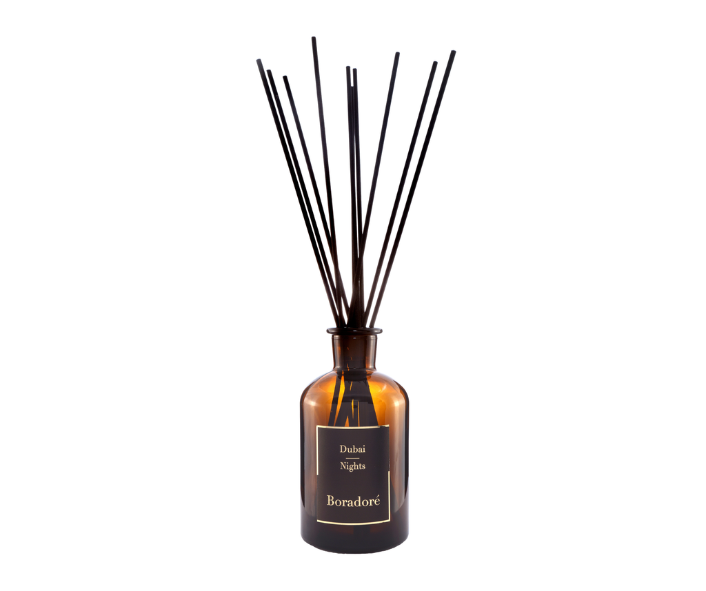 Boradoré Dubai Nights reed diffuser in amber glass bottle on white background
