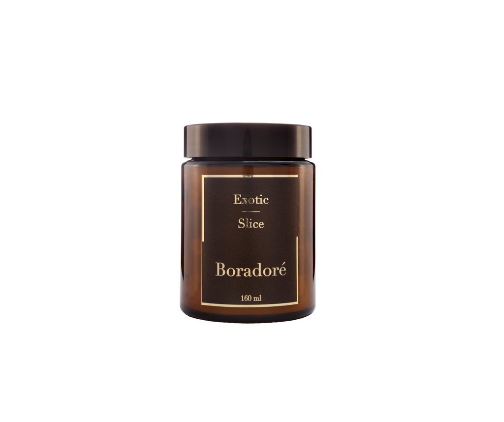 Boradoré Exotic Slice scented candle in amber glass jar on white background
