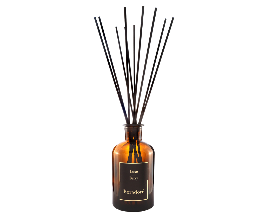 Boradoré Luxe Berry reed diffuser in amber glass bottle on white background
