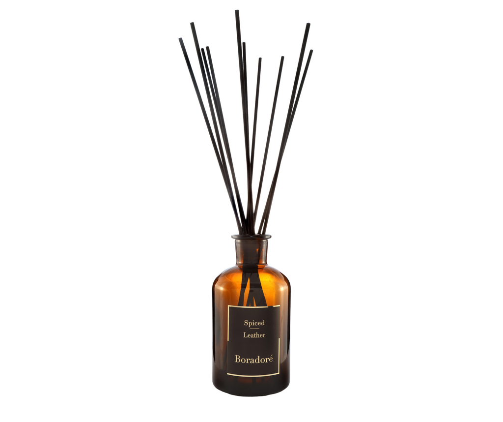 Boradoré Spiced Leather reed diffuser in amber glass bottle on white background
