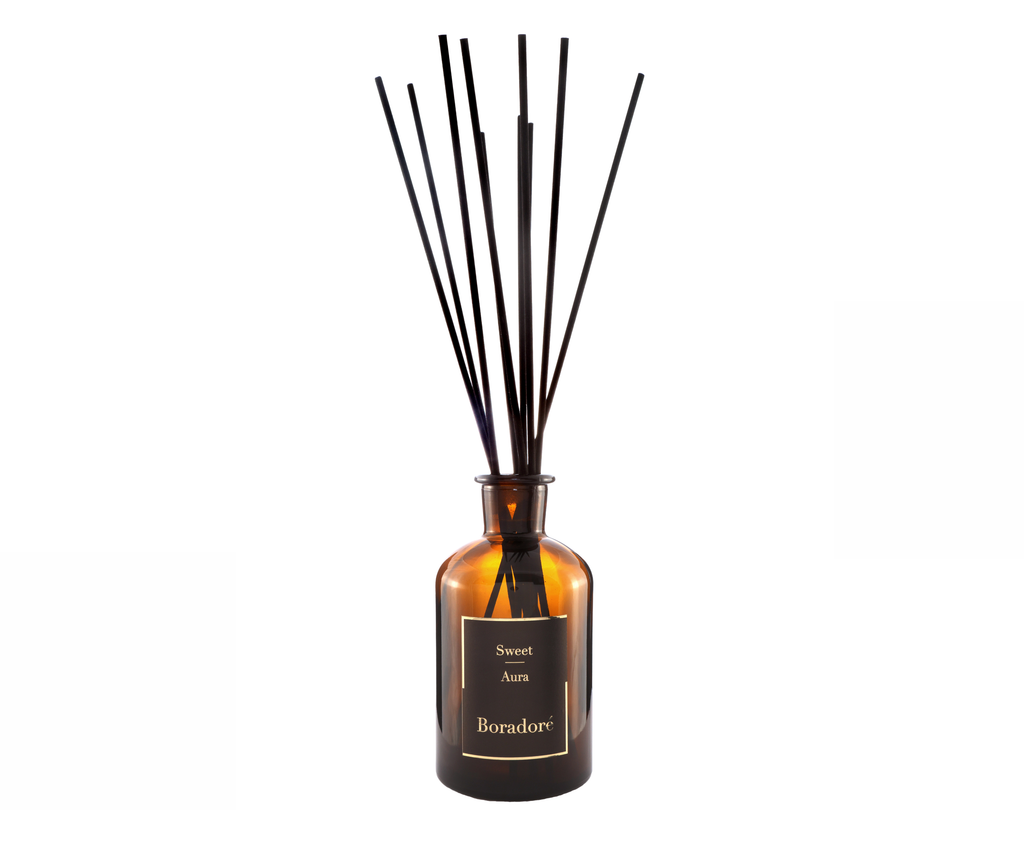Boradoré Sweet Aura reed diffuser bottle with black reeds on a white background