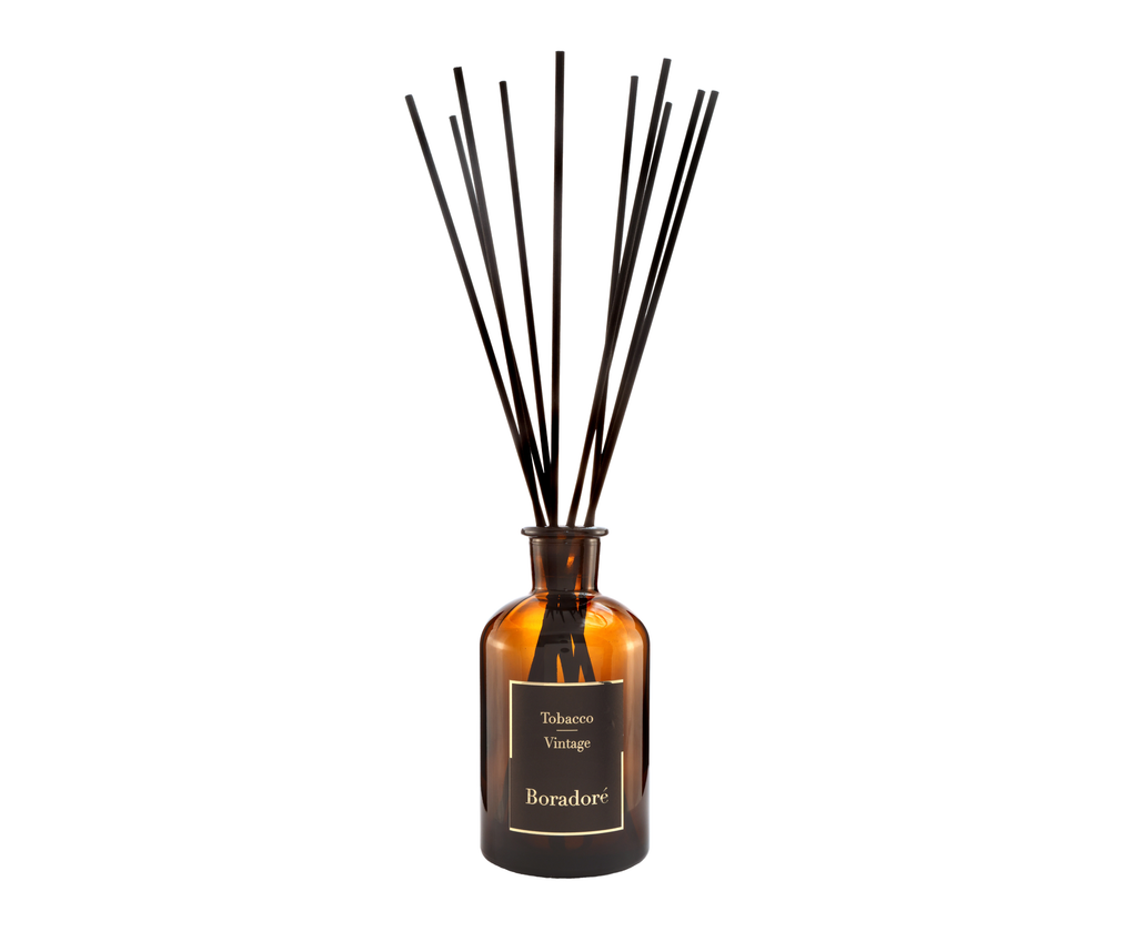 Boradoré Tobacco Vintage reed diffuser in amber glass bottle on white background
