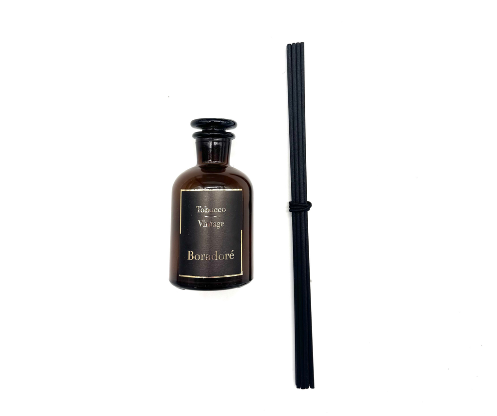 Boradoré Tobacco Vintage reed diffuser in amber glass bottle on white background
