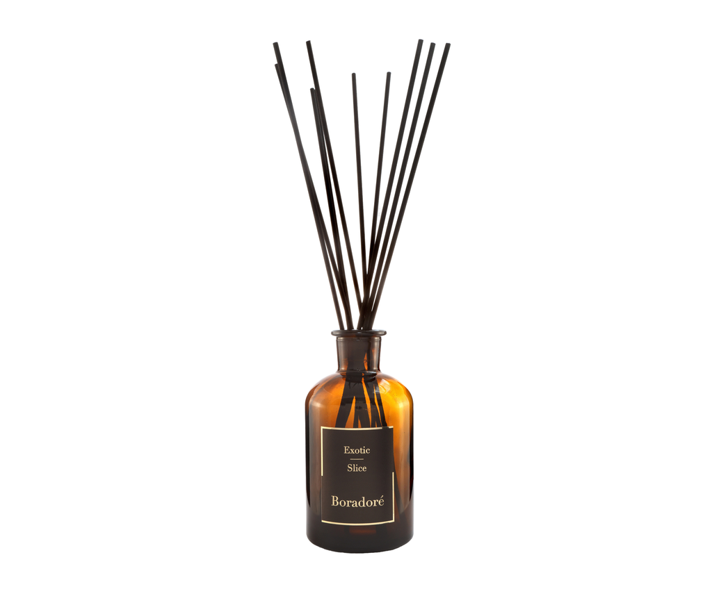 Boradoré Exotic Slice reed diffuser in amber glass bottle with black reeds on a white background